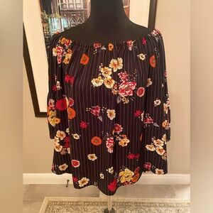 Black off shoulder floral top.